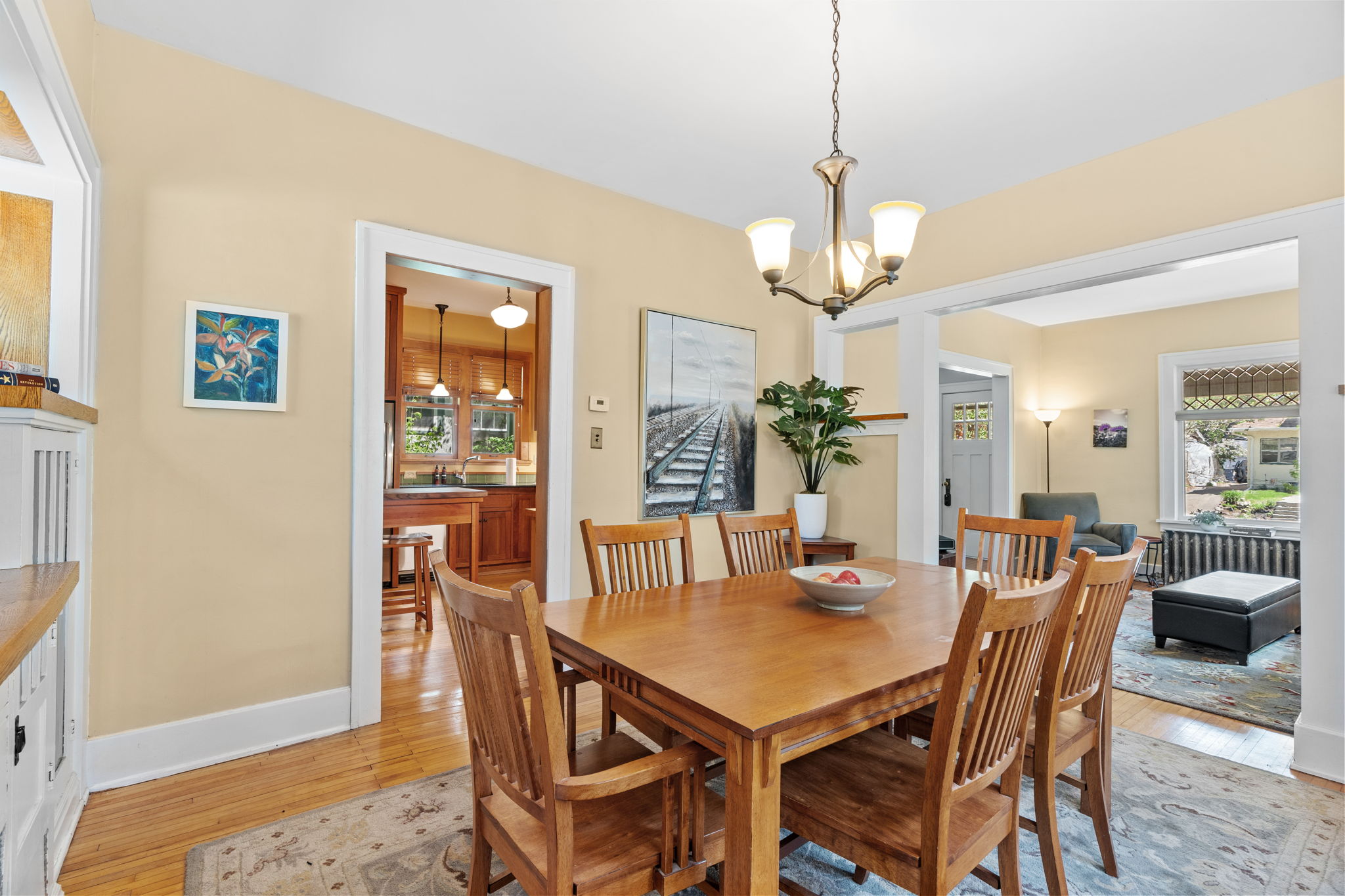 Gather around your warm wooden dining table for memorable meals and conversations in this inviting space with beautiful natural light.
