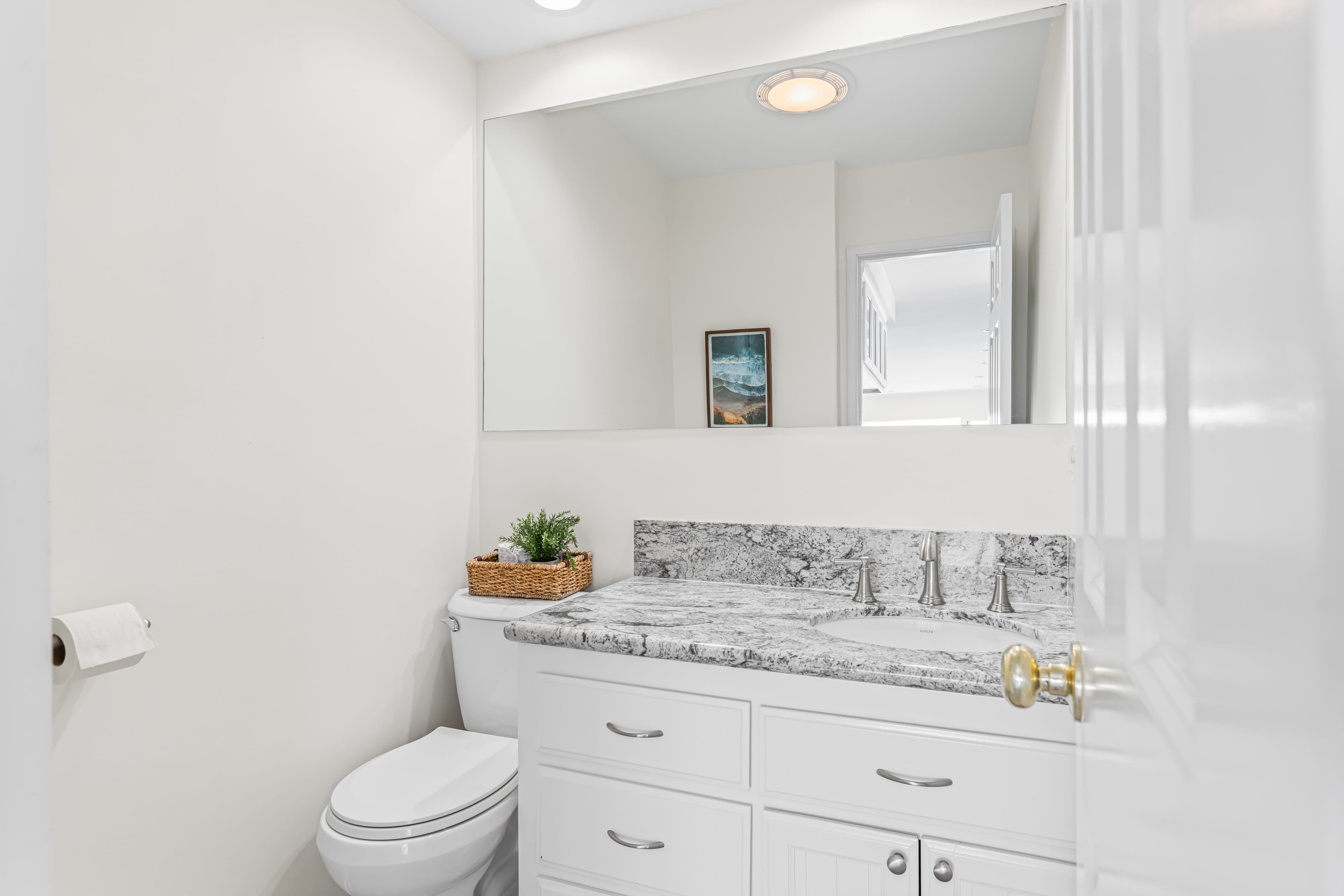 Half bathroom - located off the kitchen. Half bathroom - located off the kitchen.