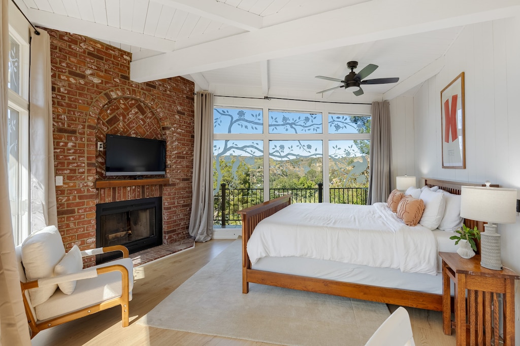 Primary bedroom 1 features a king bed, TV, and fireplace.
