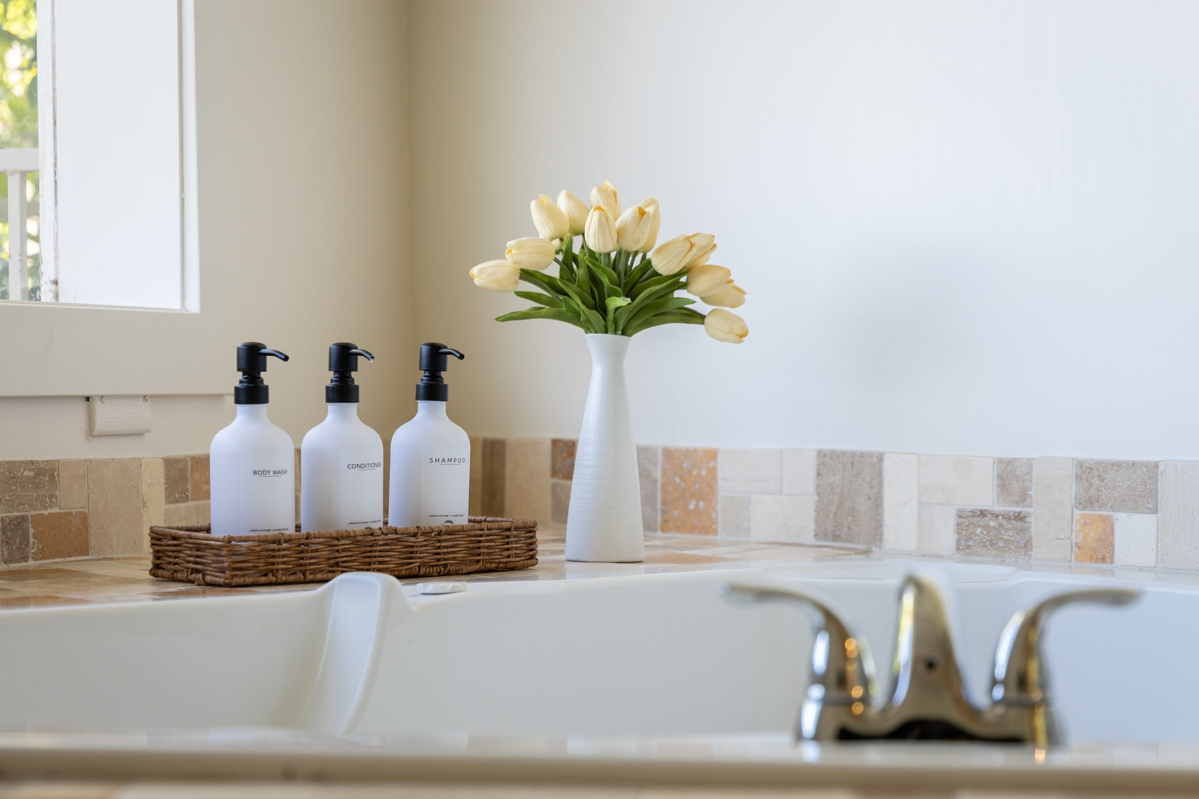 Luxurious spa tub with leafy outdoor views.