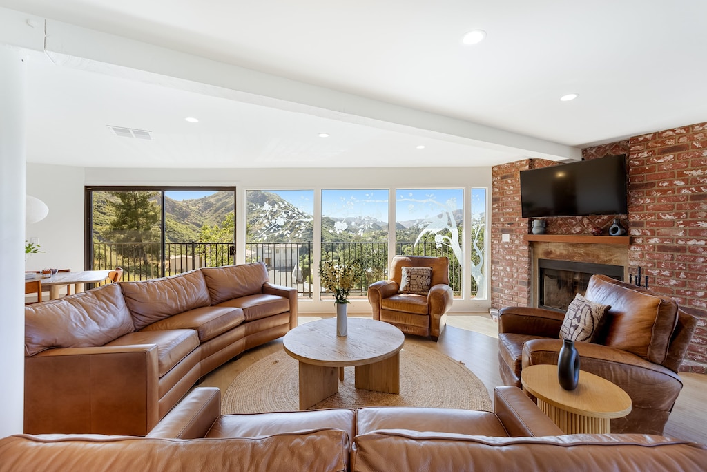 The living room offers a beautiful view of the hills in the backdrop.