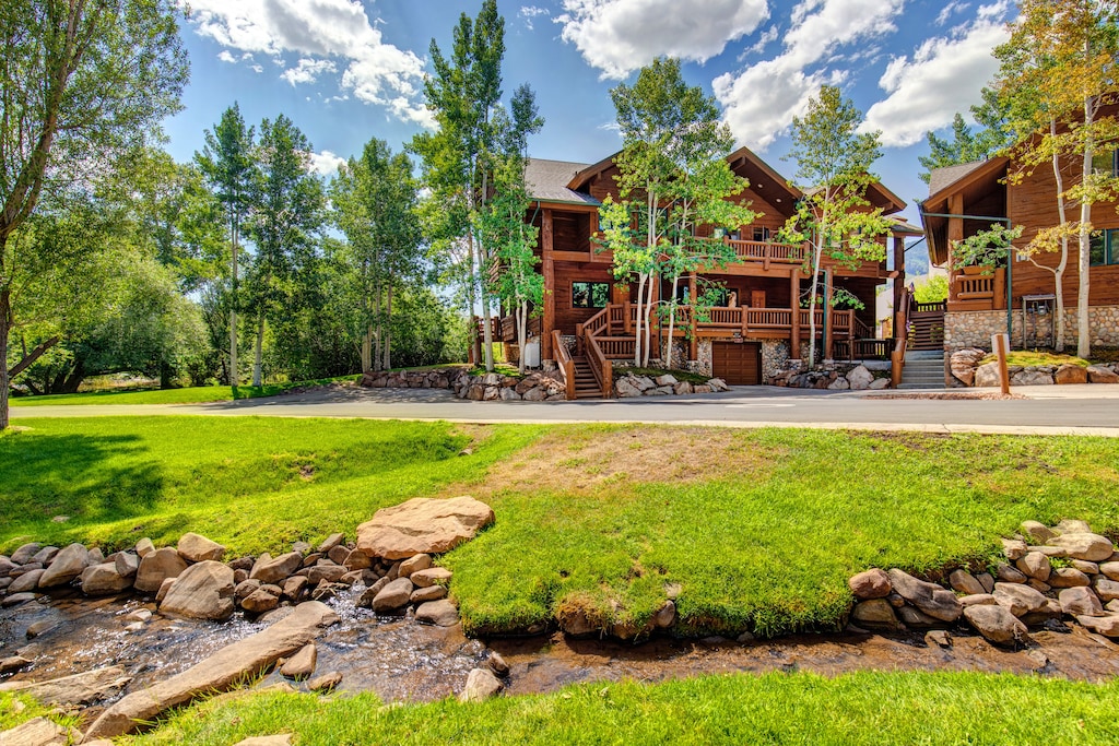 Timber Wolf Lodge 7C is surrounded by plants, trees and a babbling creek nearby.