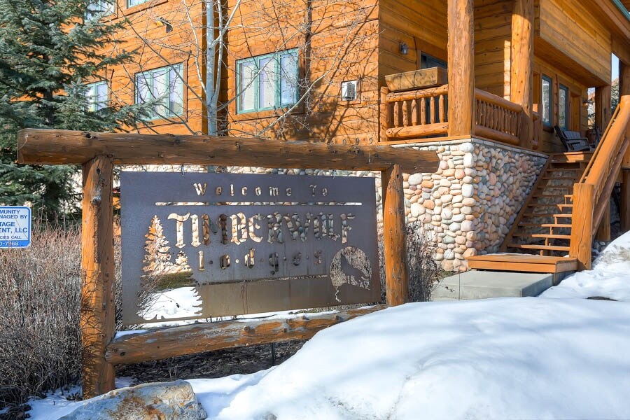 The Timber Wolf Lodge sign surrounded by snow.