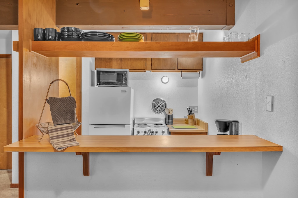 Pass through Breakfast Bar to Dining Area.  The Kitchen has all the essentials for cooking a great home cooked meal.