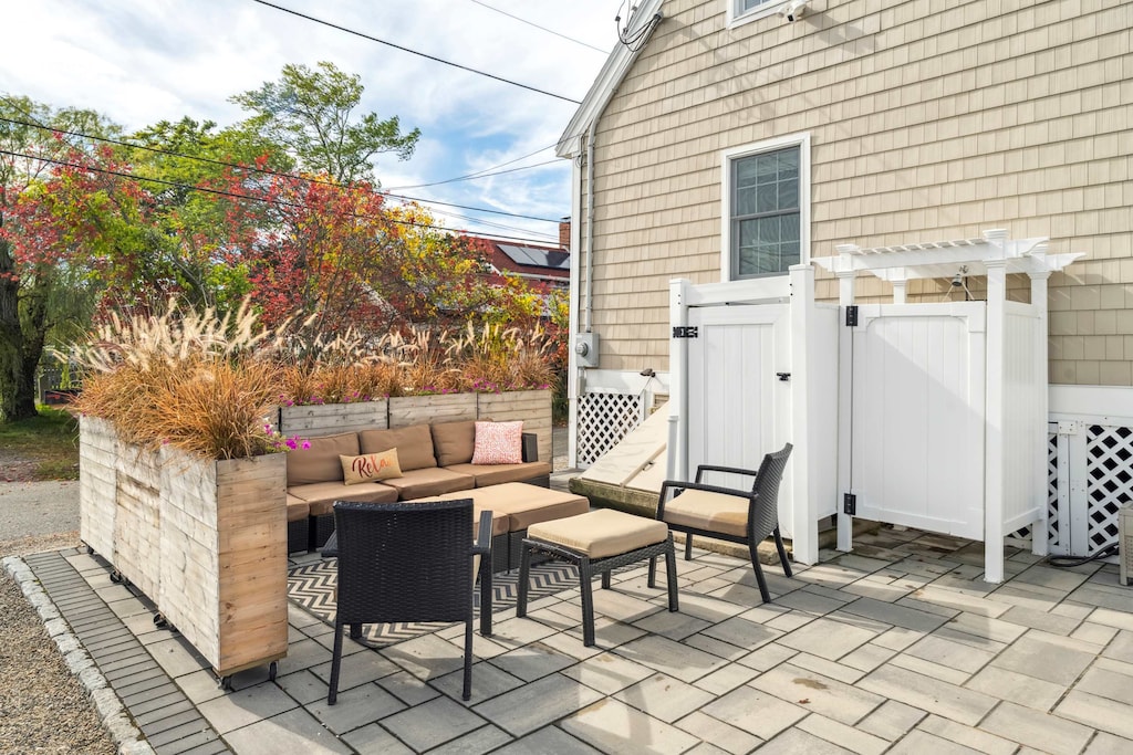 Back patio with large sectional, grill, and outdoor shower!