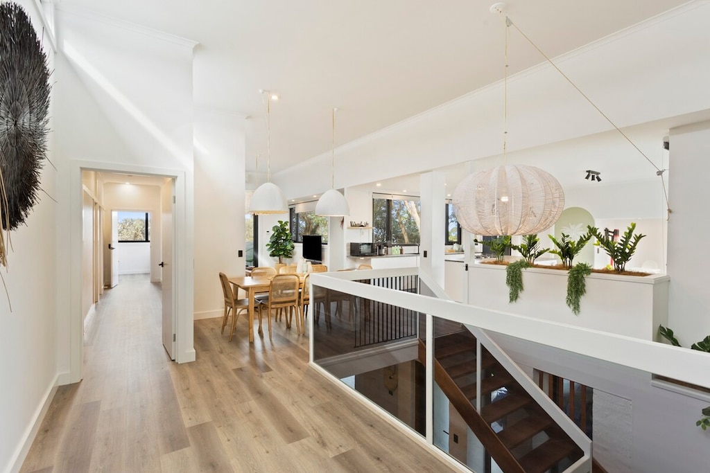 Glass Panel Staircase, hallway to bedrooms 5,6, and 7. Dining table 