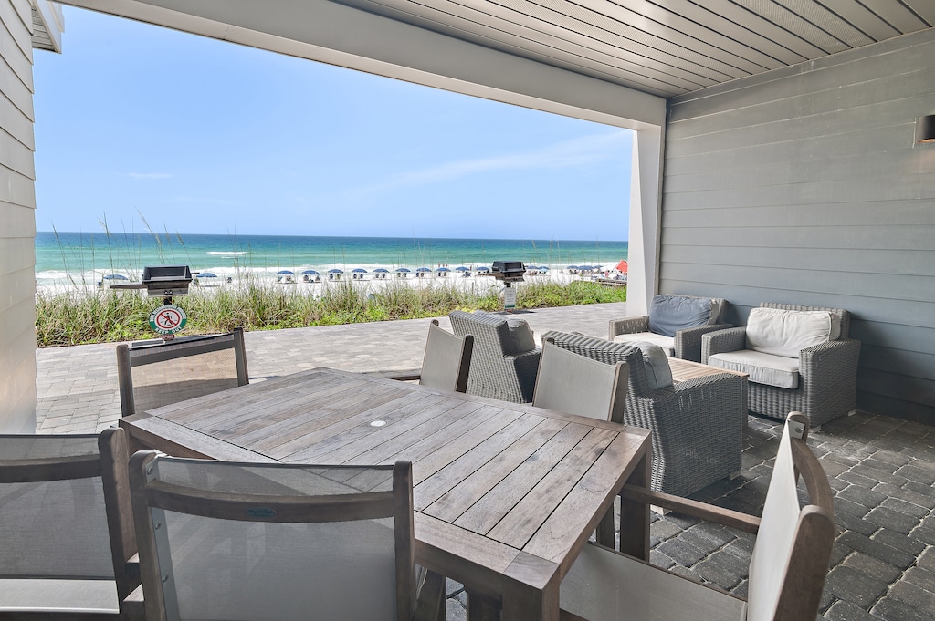 Private covered patio with seating at Henderson Beach Villa 2