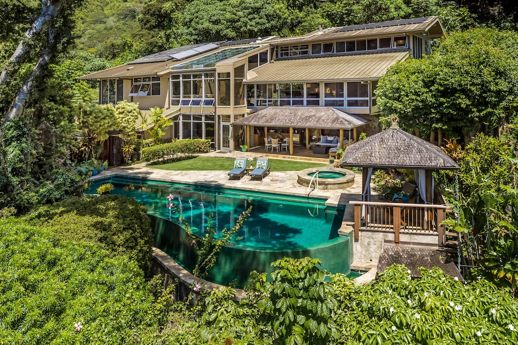 A rare hillside estate surrounded by lush landscaping and your own private poolside paradise.