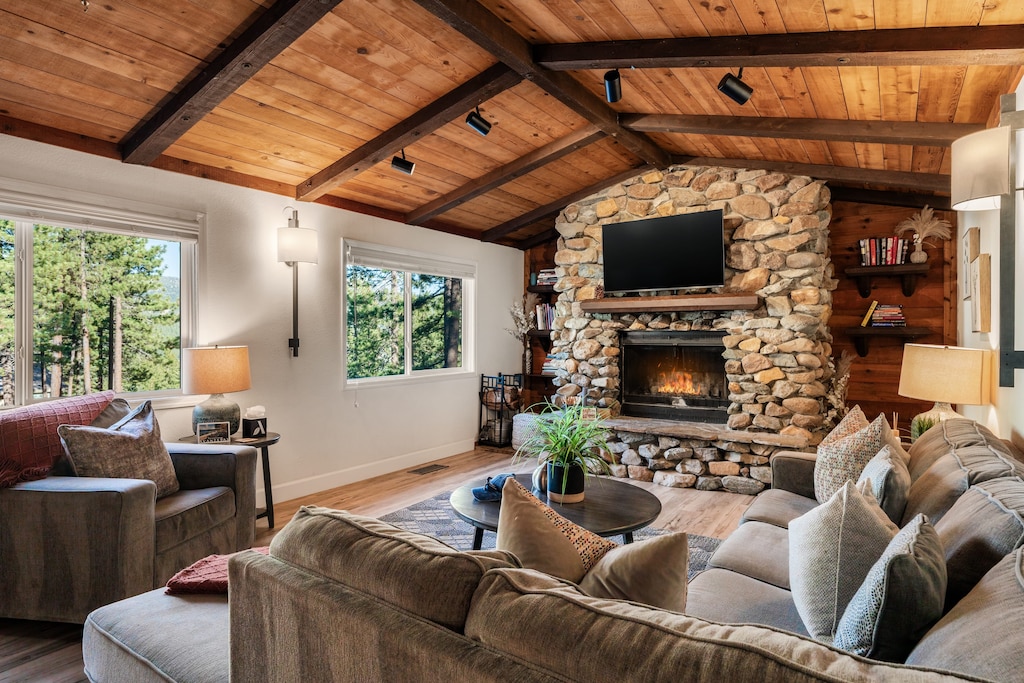 Cozy living area with comfortable seating, a fireplace, and a TV for relaxing nights in.