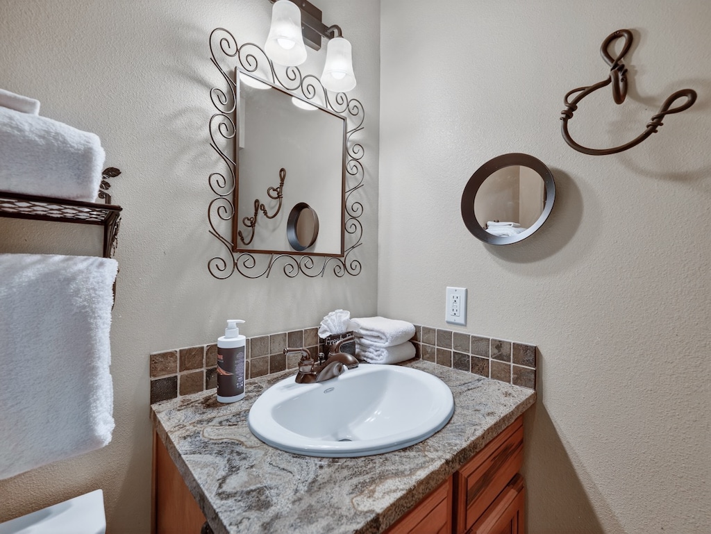 Step into your private bathroom sanctuary with elegant granite counters, ornate mirrors, and fresh linens waiting for your arrival.
