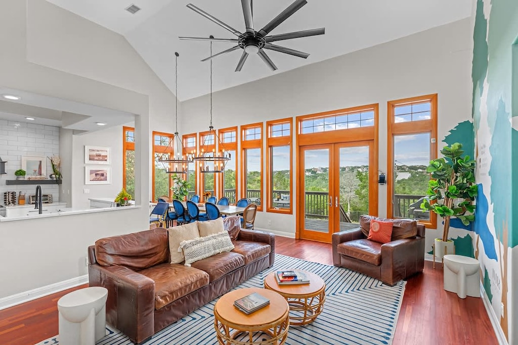 Cozy gatherings made perfect: Our living area, with a comfortable leather sofa and oversized chair, seamlessly connects to the kitchen and dining space, creating an inviting haven for shared memories and cherished moments.