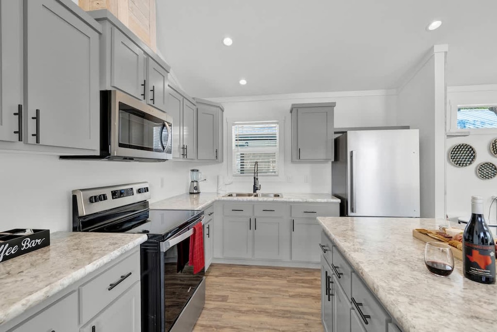 The kitchen is equipped with a stove, microwave, refrigerator and coffee pot.