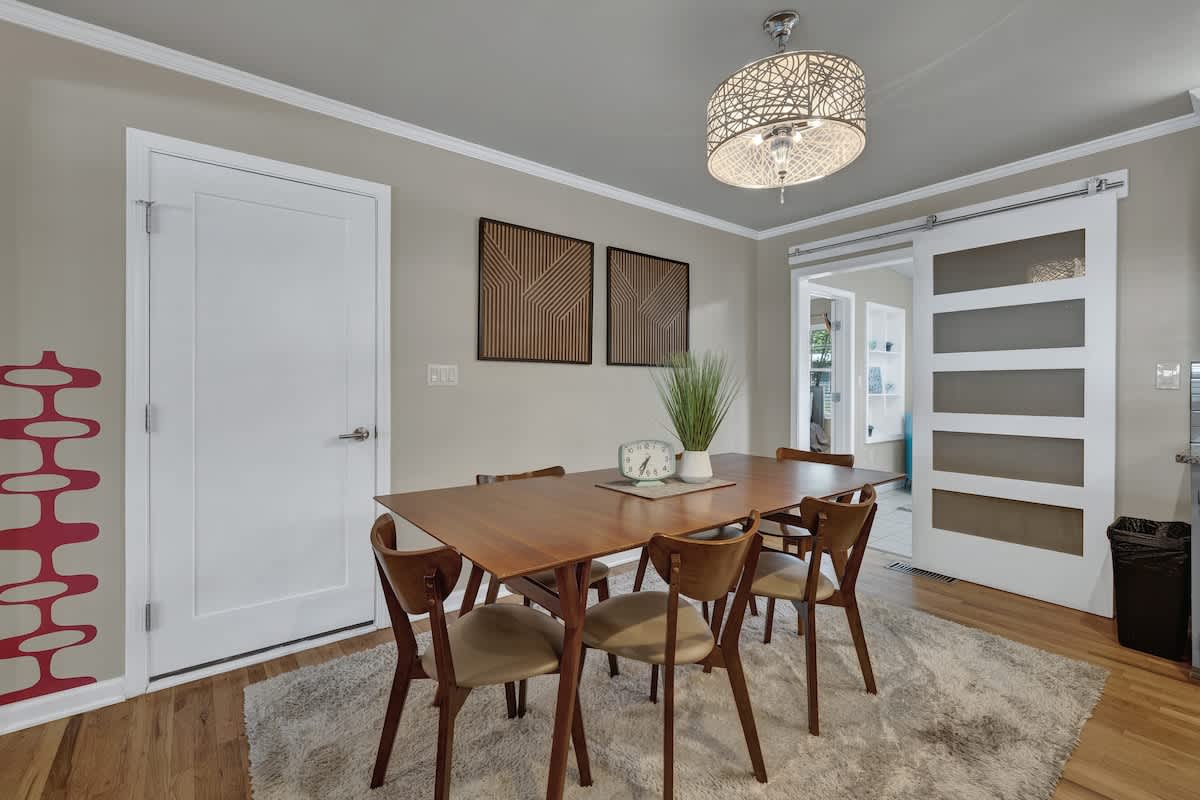 Dining table seats six with an additional three seats at the kitchen island