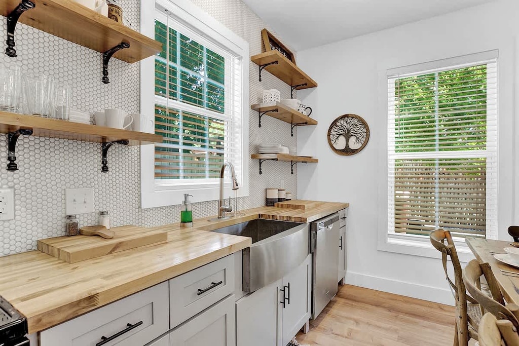 Enjoy the modern and inviting kitchen with open shelving.