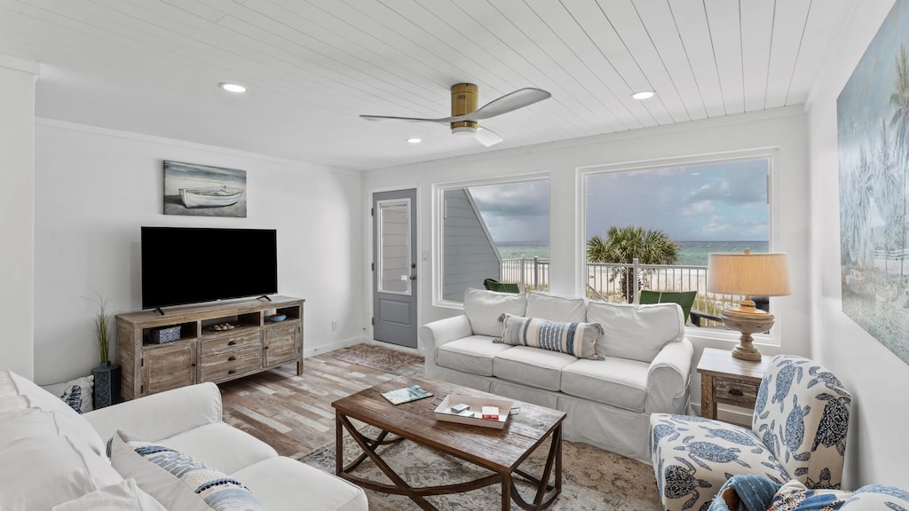 Bright living space with ocean views, sofas, and TV.