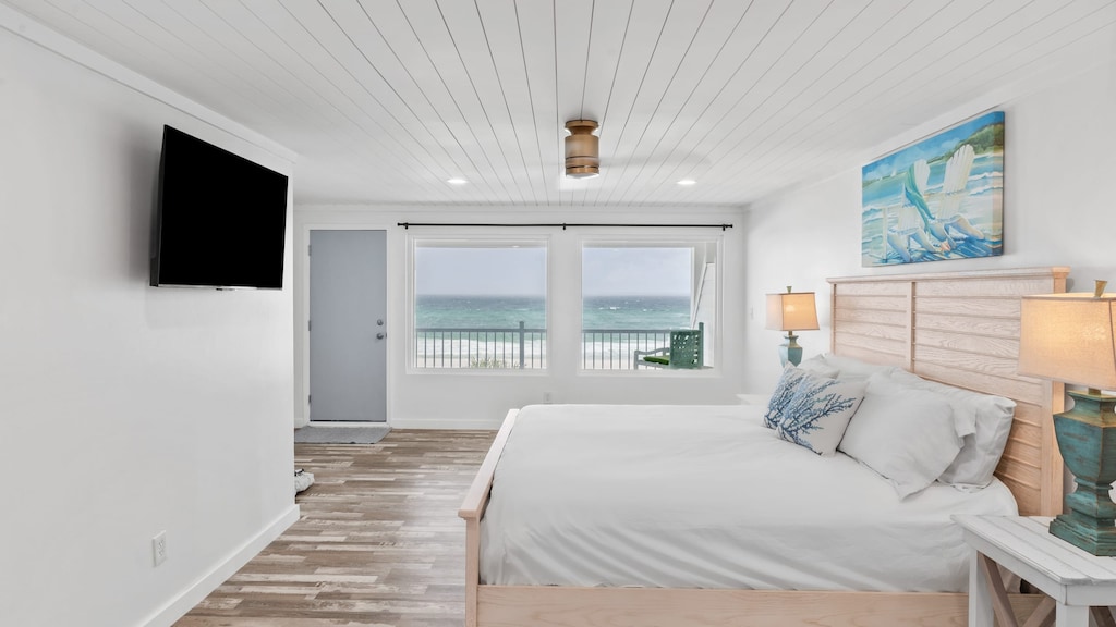 The primary bedroom features a king bed, TV, ocean views and an ensuite bathroom.