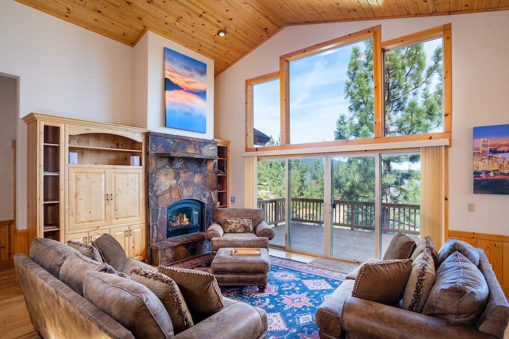 Enjoy the warmth and depth of this grand room and its open floor plan. The cathedral ceiling, wall of windows and large rock mantel gas fireplace offers breathtaking views from just about any spot in the room!