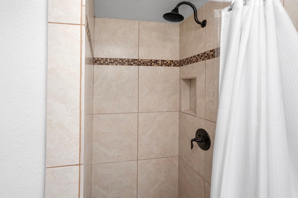 Walk-in tiled shower in the primary ensuite—spa-inspired and ideal for relaxing after a day exploring Kona.