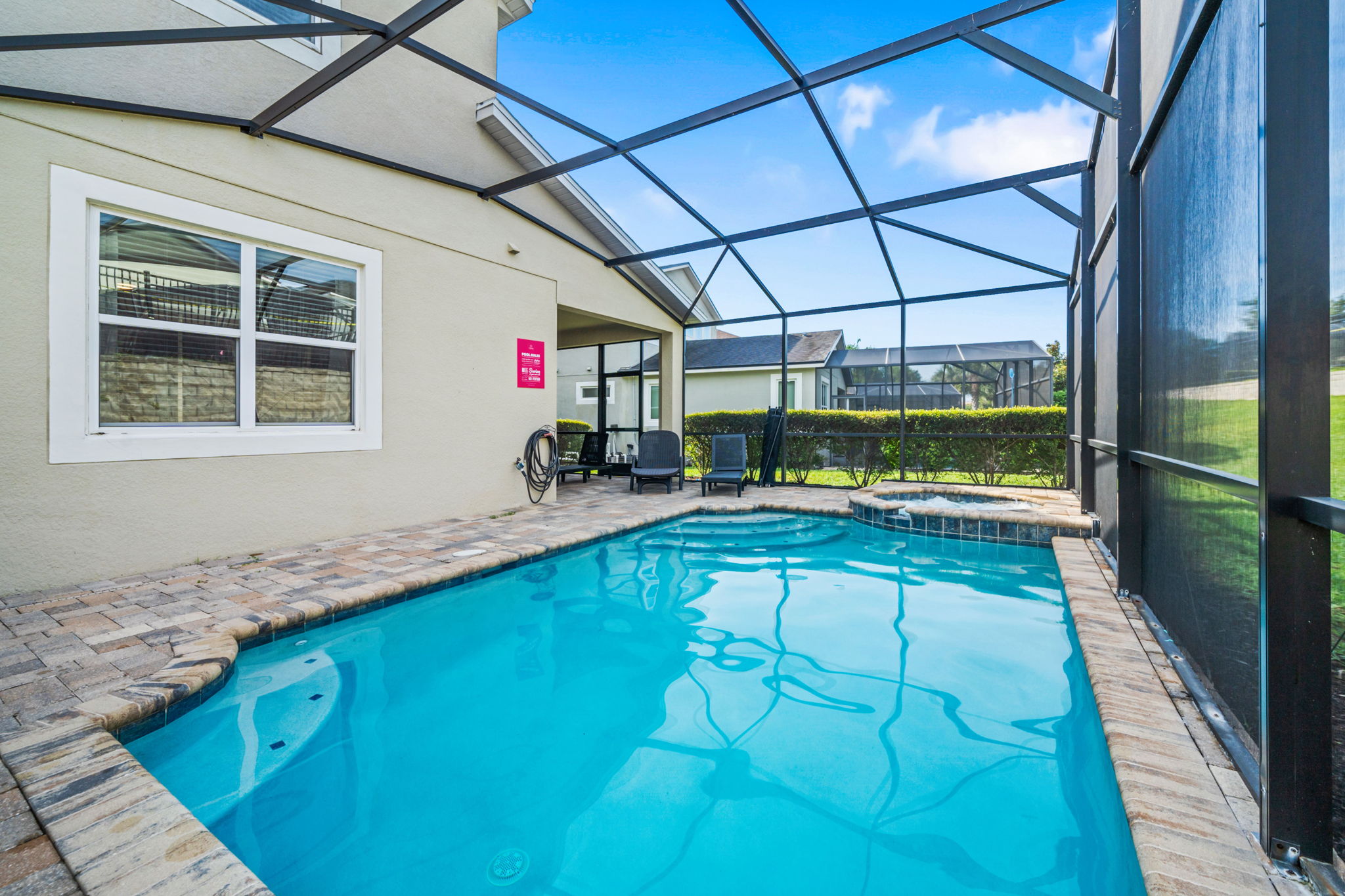 Sun-soaked patio with loungers & grill