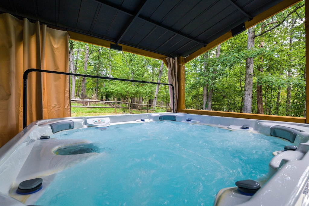 Slip into bliss! Our inviting hot tub is perfectly situated for you to soak away your worries while surrounded by the serene beauty of nature. Pure relaxation awaits.