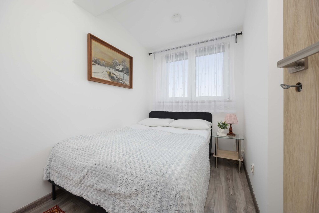 The bedroom's modern design ensures a comfortable stay.