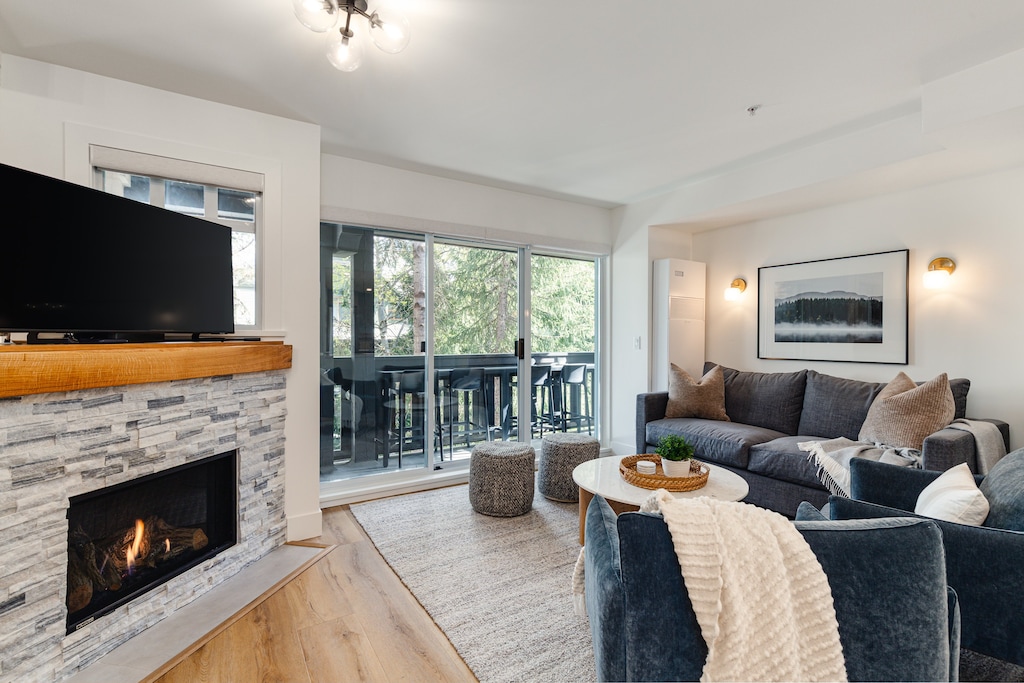 Living Room - with gas fireplace, smart TV for cable and streaming and access to one of your private patios with BBQ Grill