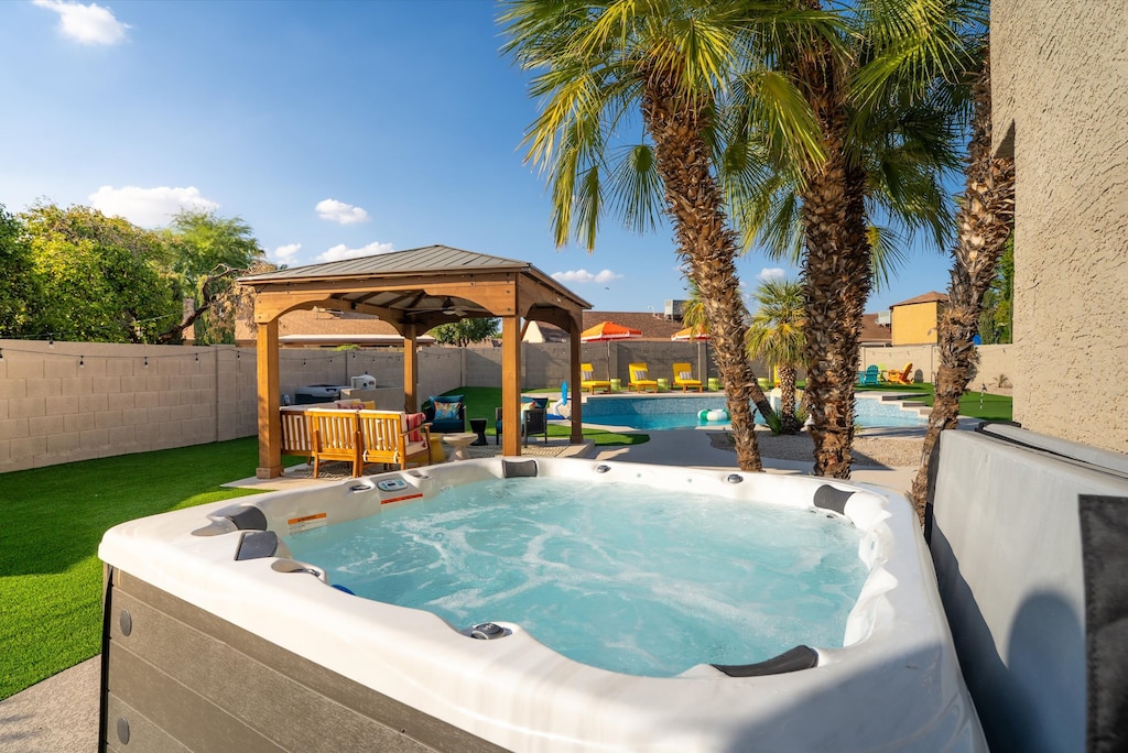 Your Stress-Free Zone Just Got an Upgrade! Forget your worries and immerse yourself in pure bliss! Our inviting hot tub is perfectly positioned for soaking away the day, while the adjacent shaded gazebo offers a fantastic spot for evening chats. 