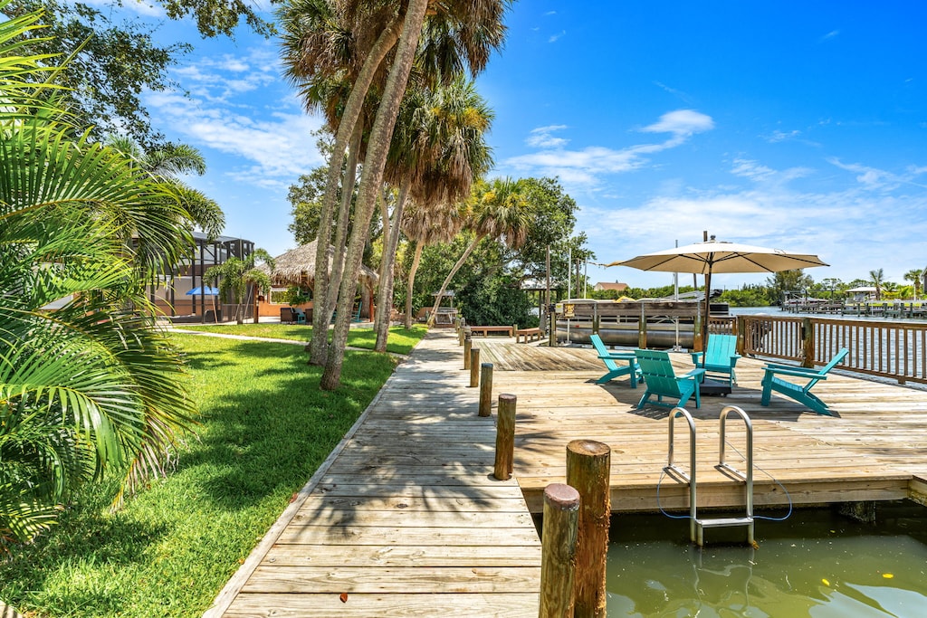 Riverfront dock with outdoor seating and umbrella for shade