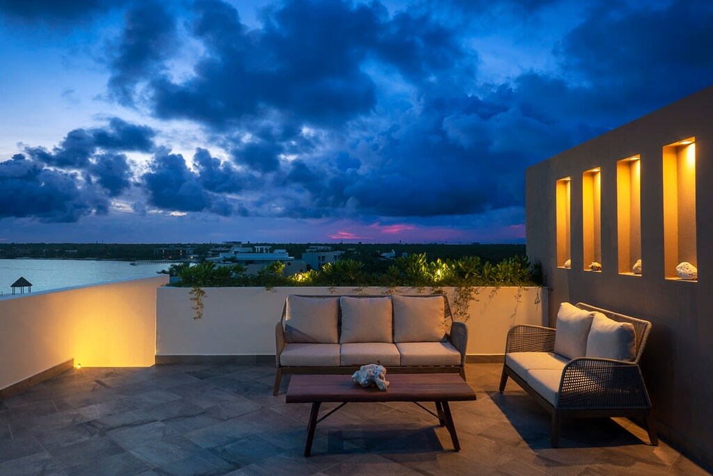 Breathtaking sunset viewed from the balcony. Comfortable chairs for enjoying the sea views.
