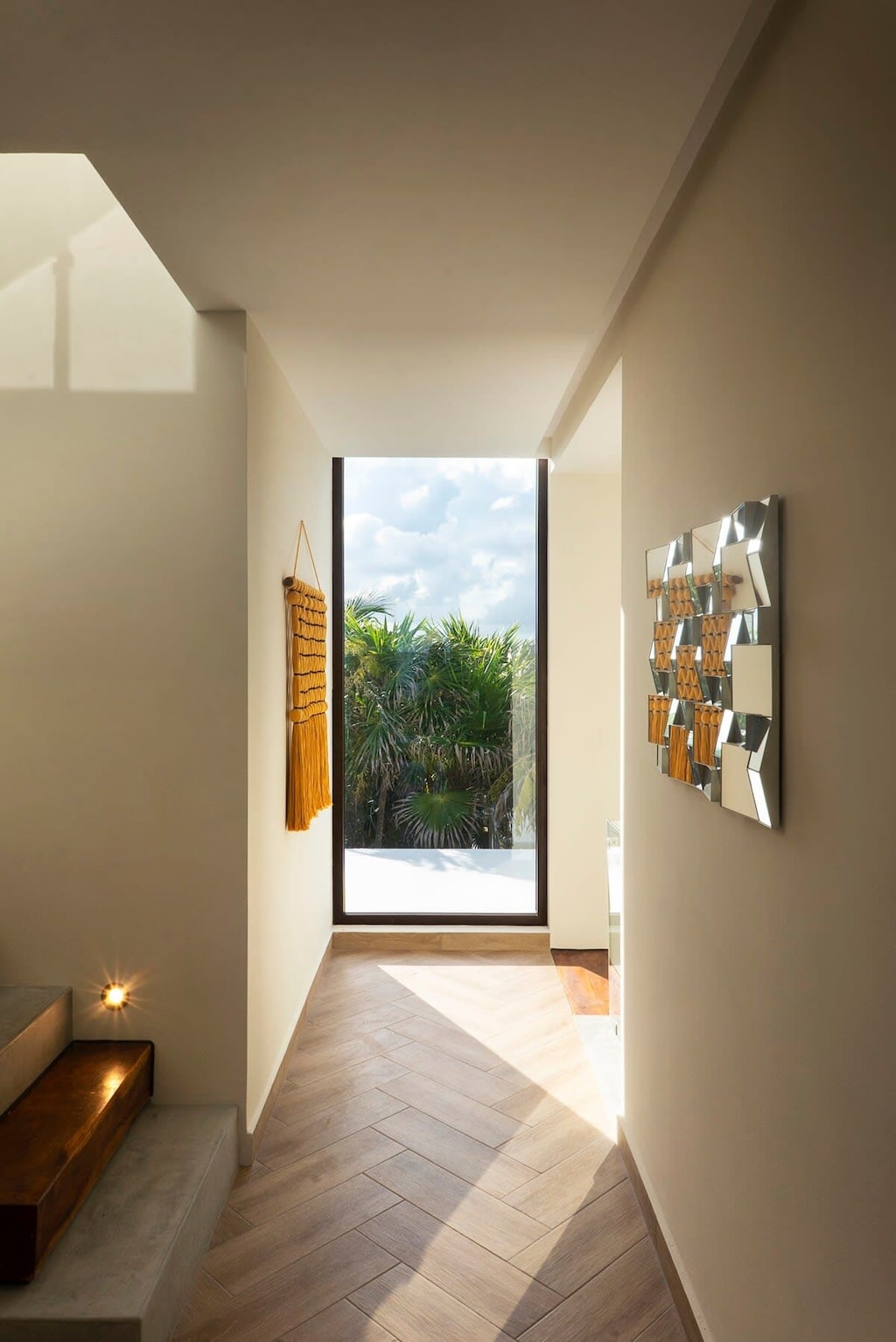 Modern hallway with a beautiful window that allows a view of the exterior landscape.