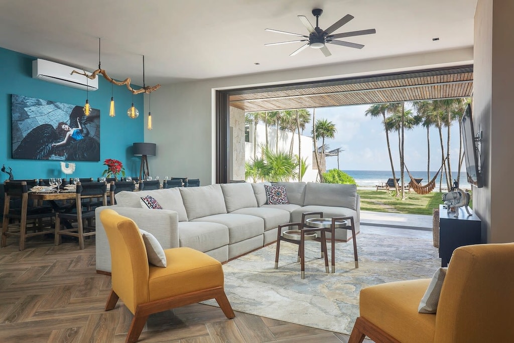 Spectacular living room with TV and amazing view of the patio and ocean.