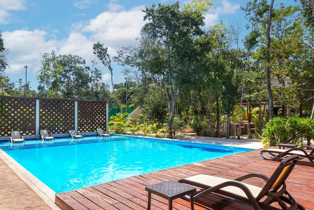 Impressive deck with sun loungers for enjoying the pool.

