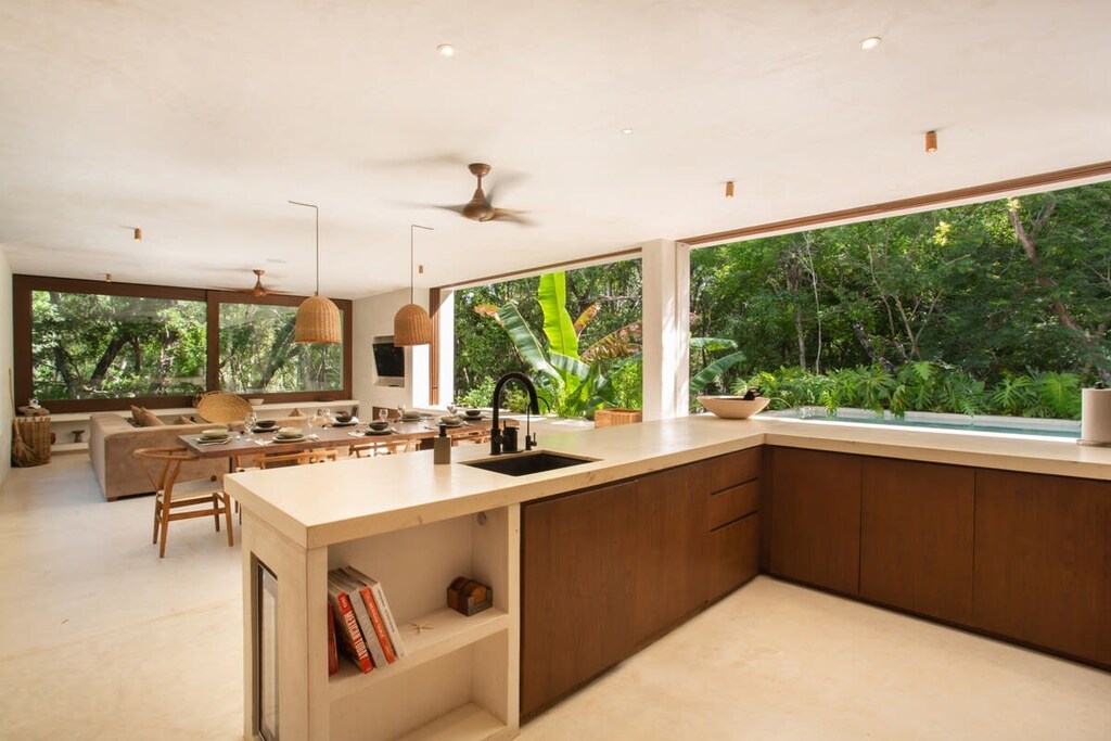 Modern and elegant kitchen with an L-shaped countertop. Connected in an open concept space with the living and dining areas.
