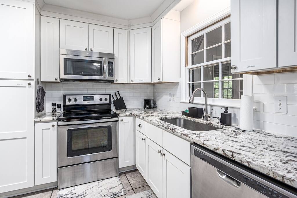 Stocked kitchen with coffee maker, tea, and cooking supplies (pots, pans, utensils, blender, etc.)