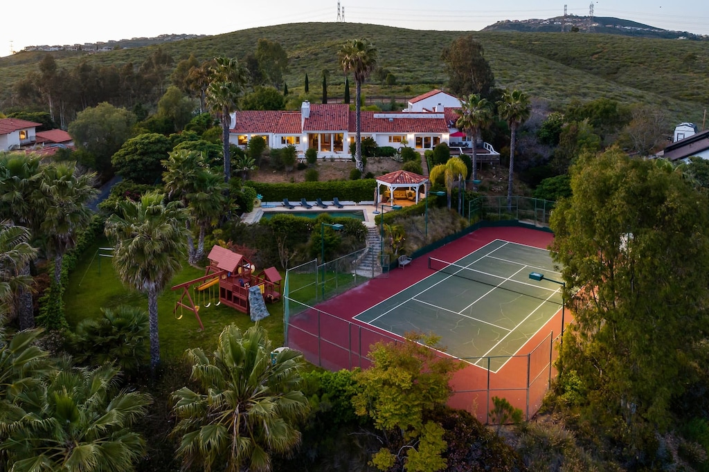 This resort-like backyard offers something for everyone, from the tennis enthusiast to the sunbather. (TheTennis Ranch)