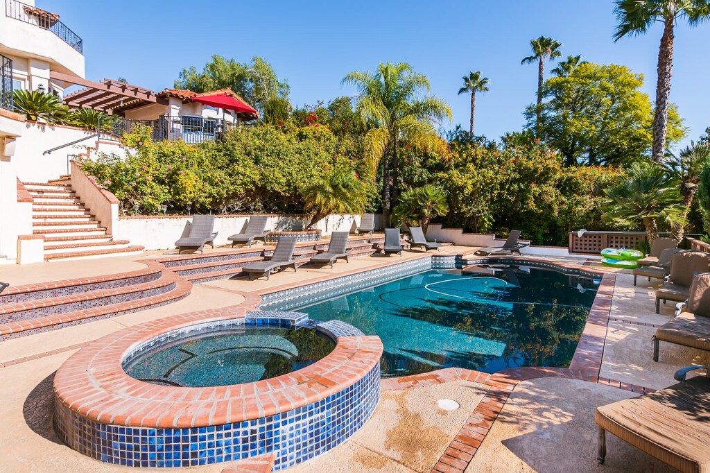 Escape the everyday with a private pool and jacuzzi, surrounded by lush landscaping. (The Ranch)