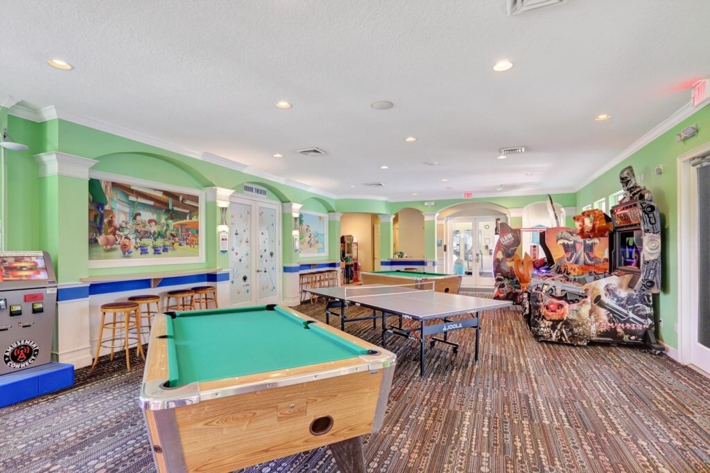 Spacious game room with pool table and plenty of entertainment options.
