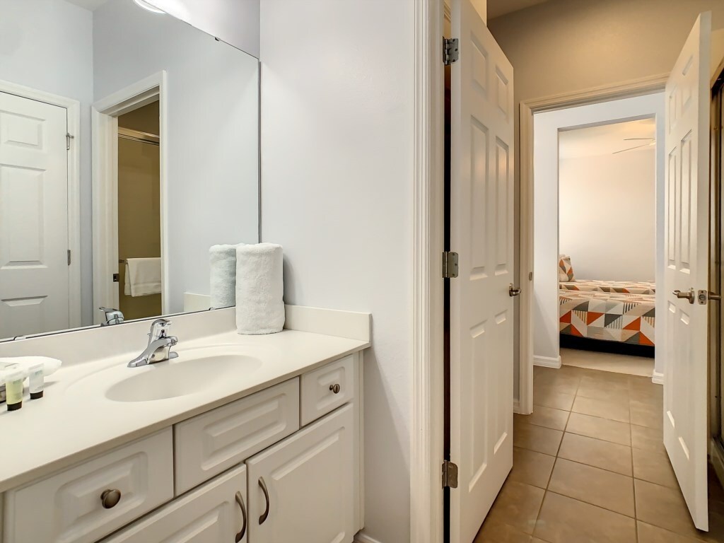 Convenient bathroom with a modern sink and storage space.