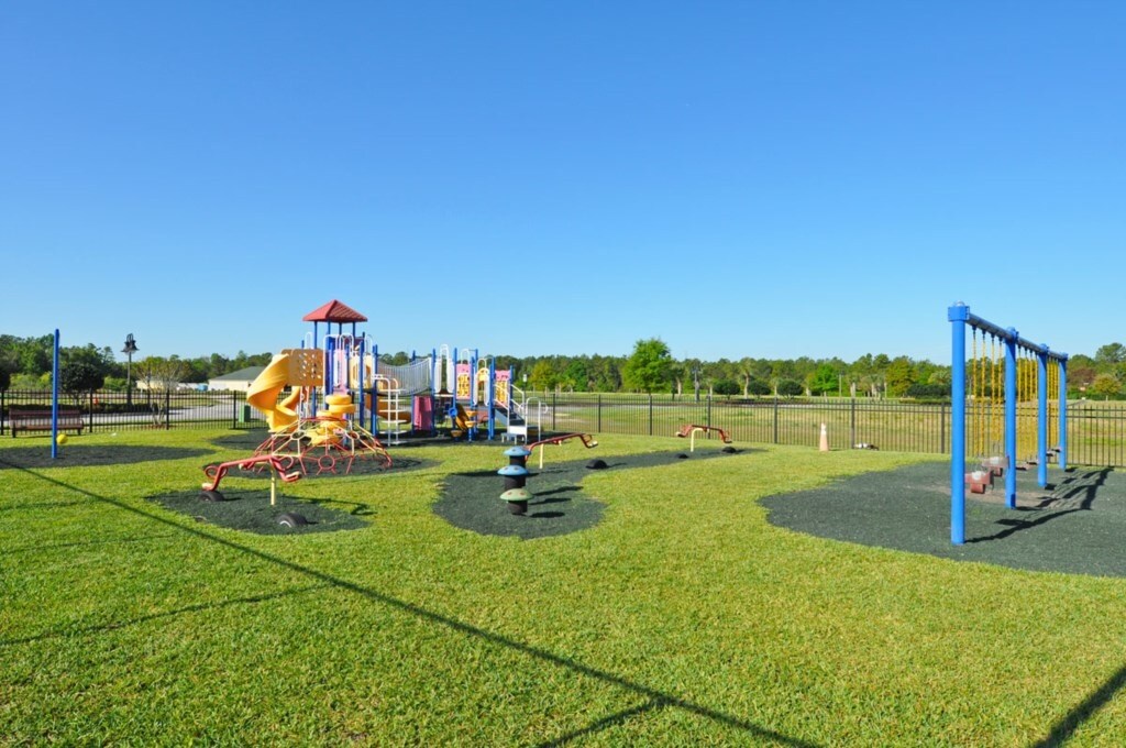 Spacious playground with open green areas for kids to enjoy.