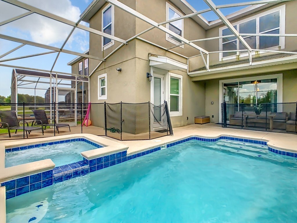 Stunning pool and spa area with a fenced-in patio for ultimate relaxation.