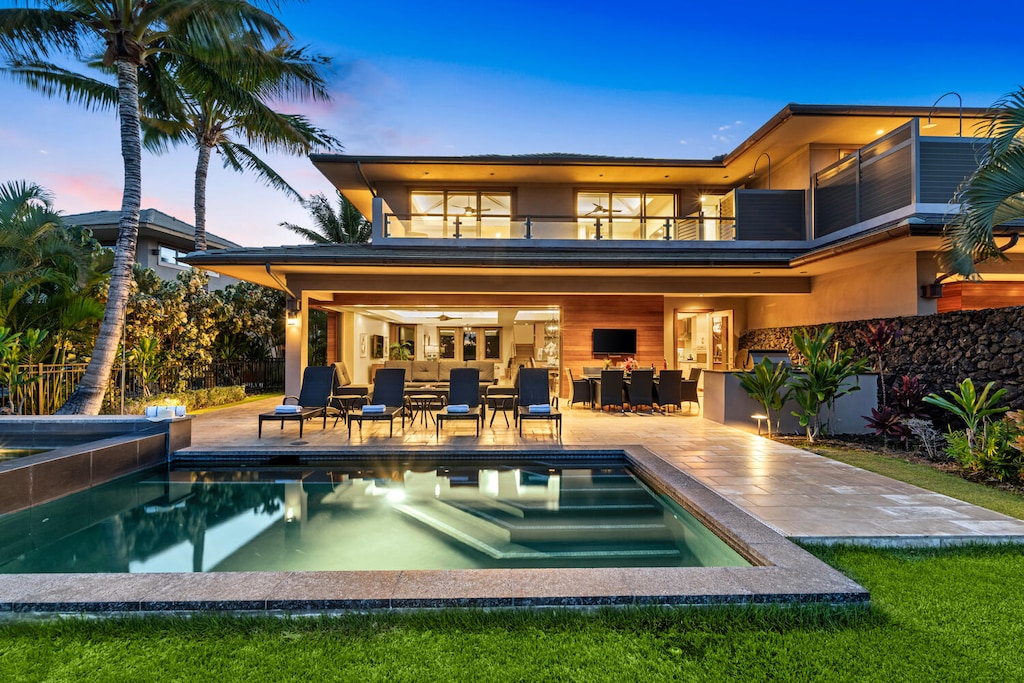 Evenings glow at this resort-style villa with a poolside lanai for entertaining at Laule'a #14.