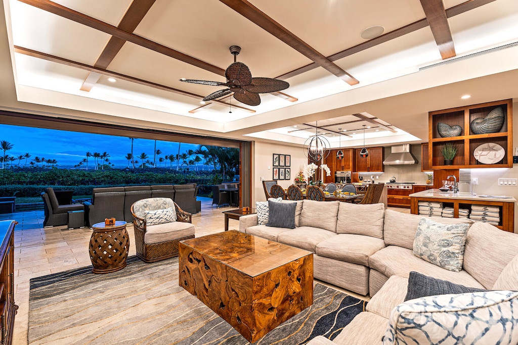 Open-concept great room with plush seating flows seamlessly to the covered lanai at Laule'a #13.
