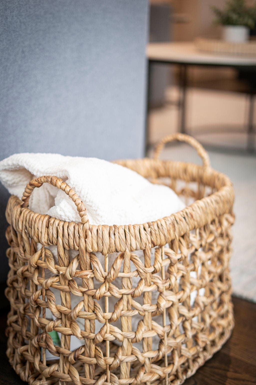 Fresh towels await in this charming woven basket, adding natural warmth to your home away from home.