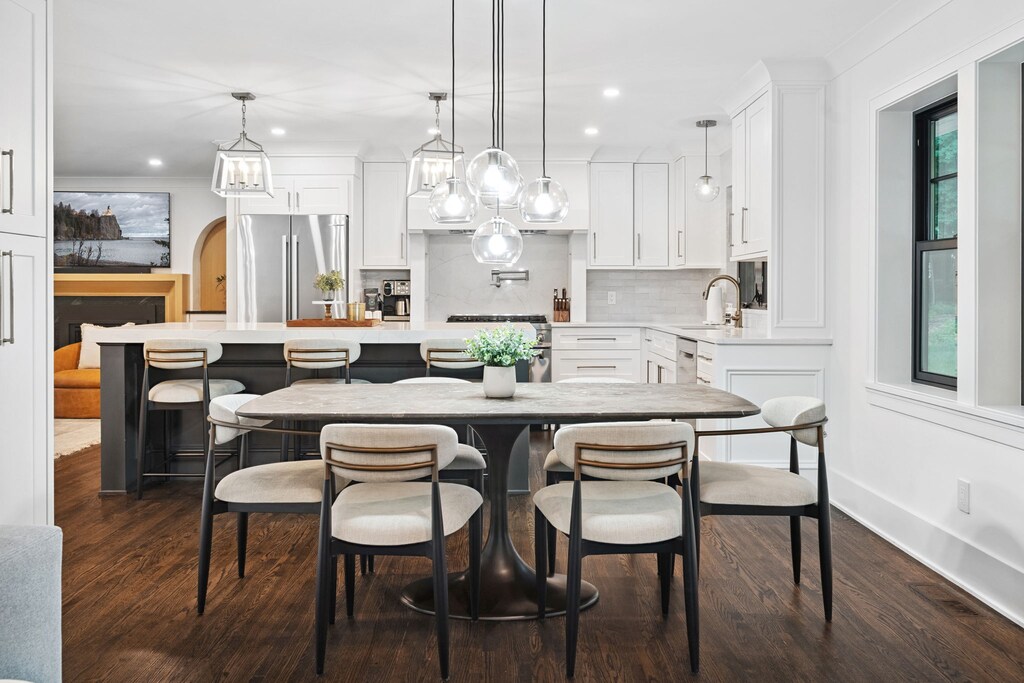 Your stunning open-concept kitchen invites culinary adventures with sleek white cabinetry, modern appliances, and an elegant dining area perfect for memorable meals.