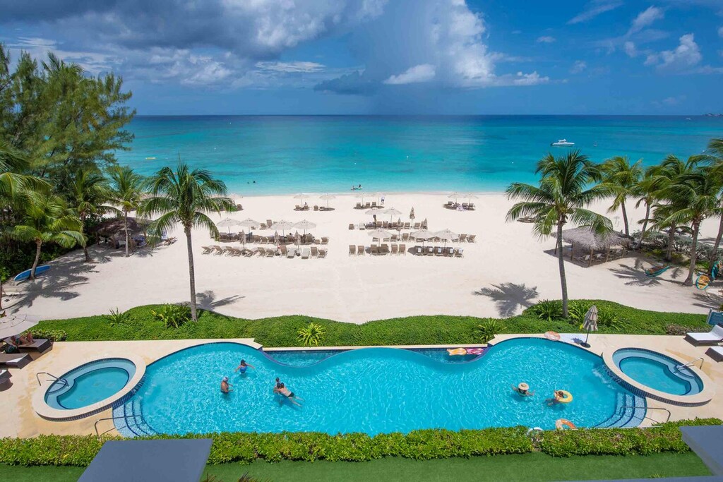 Views of the resort's pool, heated spas, and daily beach service.