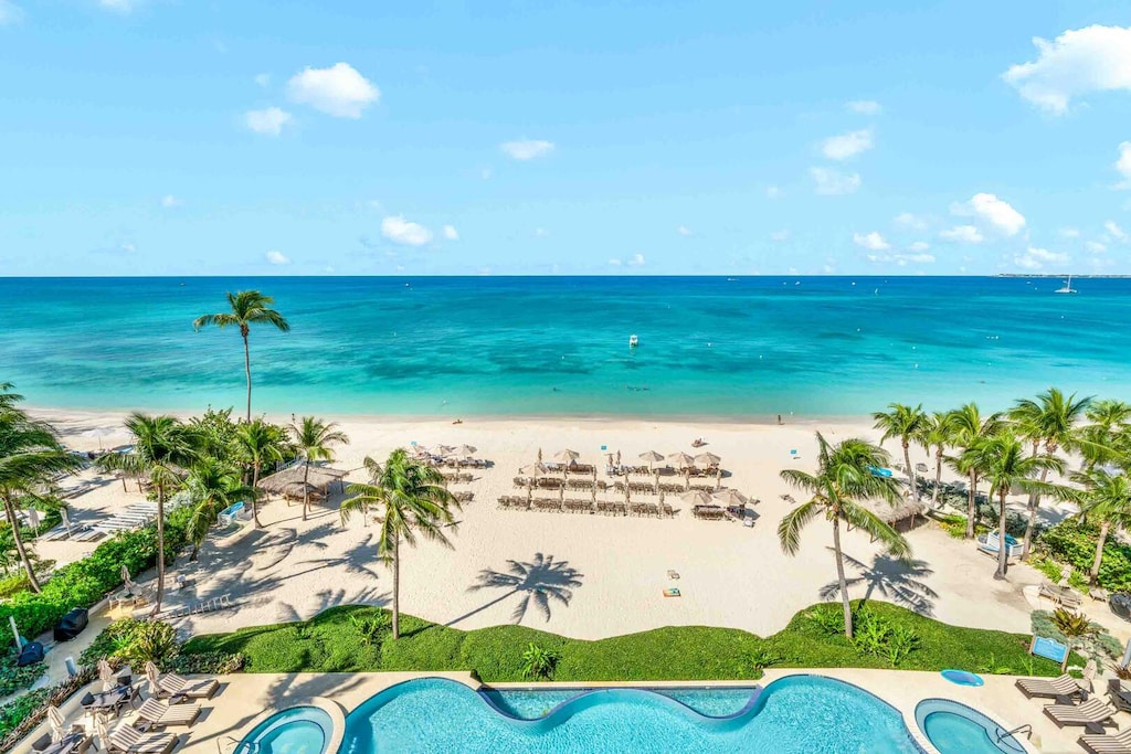 Balcony views of the Beachcomber's pool, hot tubs, and daily beach service.