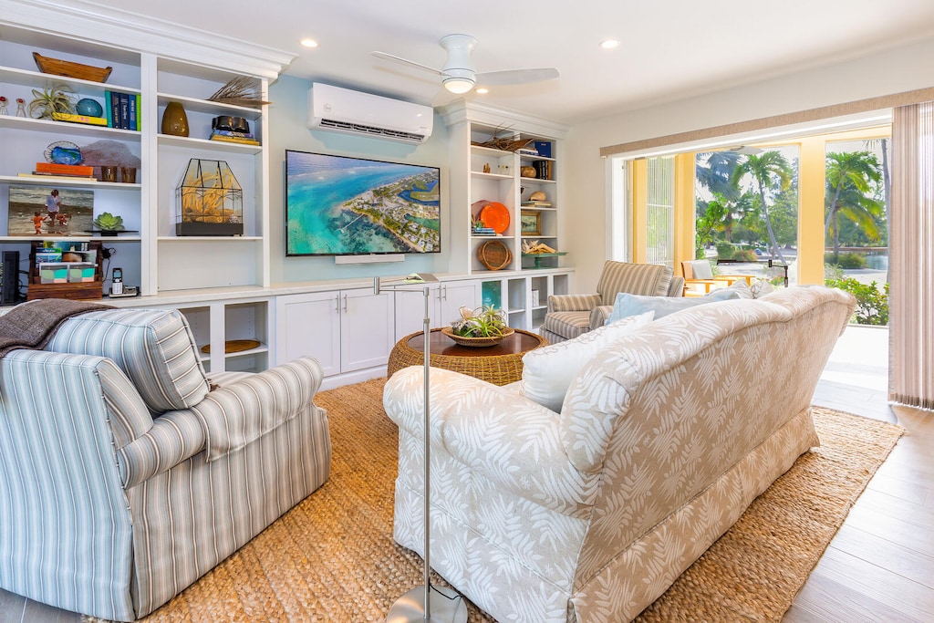 Comfy living area with screened patio in the background.