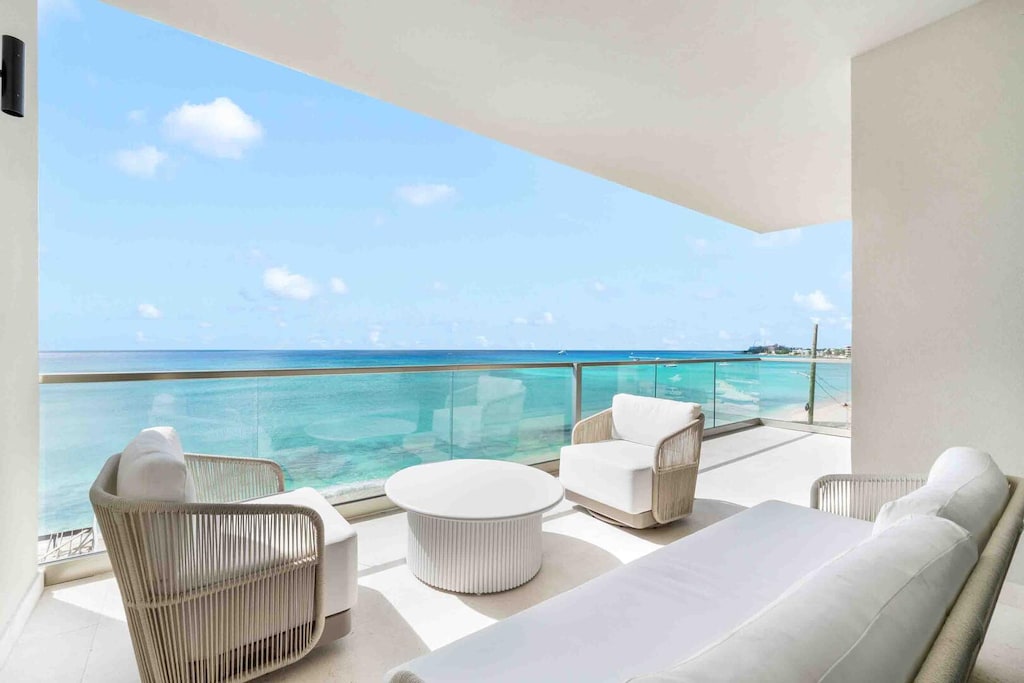 The private furnished balcony provides elevated oceanfront views.