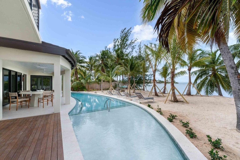 Private pool and sandy beachfront.