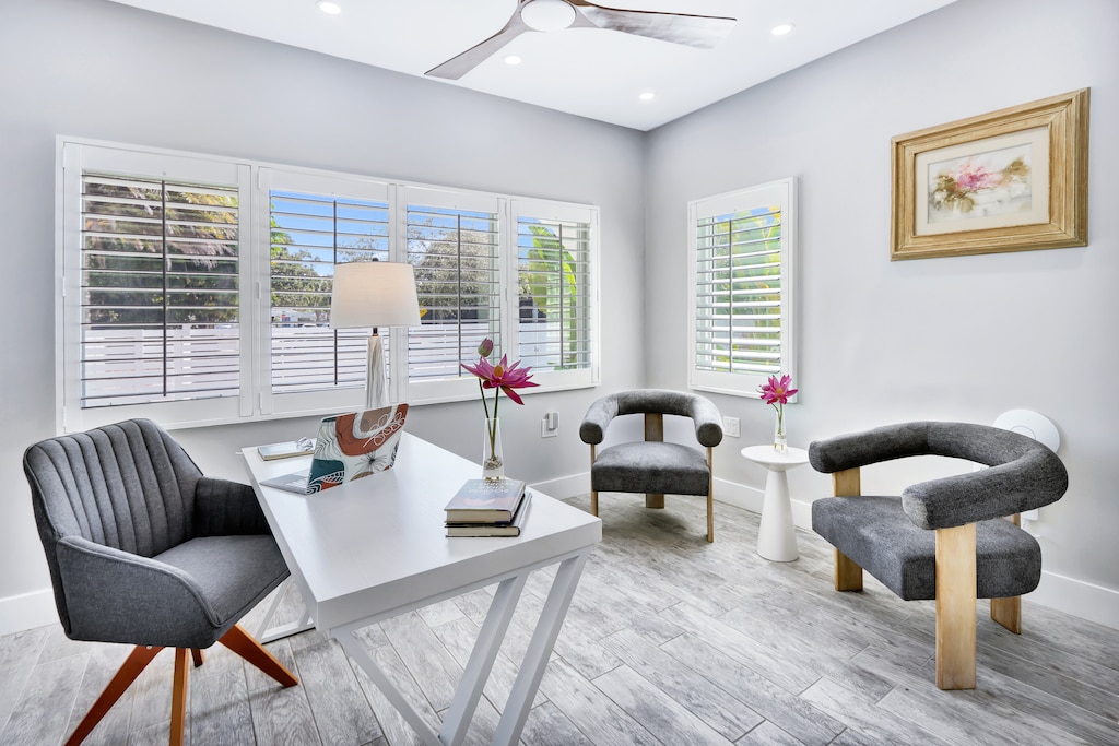 Den | A small, private bonus den offers a large desk, and additional seating.